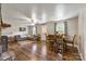 Open-concept living room with hardwood floors, a cozy couch, and a dining table, ideal for entertaining guests at 3980 English Oak Dr, Lincolnton, NC 28092
