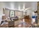 Spacious living room with hardwood floors, a comfortable couch, and a dining area, perfect for gatherings at 3980 English Oak Dr, Lincolnton, NC 28092