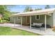 Covered back patio with stylish seating offers an inviting spot for relaxation and outdoor living at 3980 English Oak Dr, Lincolnton, NC 28092