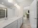 Bright bathroom with dual sinks and a view into the adjacent bedroom at 416 Linestowe Dr, Belmont, NC 28012