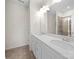 Modern bathroom featuring dual sinks, white cabinets, and wood-look floors at 416 Linestowe Dr, Belmont, NC 28012