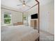 Bright bedroom with a canopy bed and two windows providing natural light at 416 Linestowe Dr, Belmont, NC 28012
