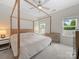 Bright bedroom with a canopy bed and two windows providing natural light at 416 Linestowe Dr, Belmont, NC 28012