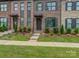 Charming brick townhome featuring well-maintained landscaping and a welcoming entryway, providing an inviting curb appeal at 416 Linestowe Dr, Belmont, NC 28012