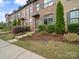 Attractive exterior view of brick townhome with well-manicured lawn and tidy landscaping at 416 Linestowe Dr, Belmont, NC 28012
