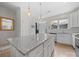 Modern kitchen featuring a granite countertop island, white cabinets, and stainless steel appliances at 416 Linestowe Dr, Belmont, NC 28012
