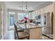 Modern kitchen boasts stainless steel appliances, an island with bar seating, and ample cabinet space for culinary enthusiasts at 416 Linestowe Dr, Belmont, NC 28012