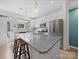 Open kitchen with a granite island, white cabinets, and stainless steel appliances, including a refrigerator at 416 Linestowe Dr, Belmont, NC 28012