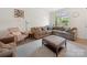 Comfortable living room with a sectional sofa, patterned rug, and a well-lit space at 416 Linestowe Dr, Belmont, NC 28012
