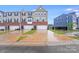 Charming townhome exterior with brick accents, gray siding, and inviting curb appeal on a wet day at 416 Moondance Dr # 121, Gastonia, NC 28054