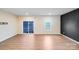Bright, empty living room featuring hardwood floors and sliding glass door with backyard view at 416 Moondance Dr # 121, Gastonia, NC 28054