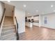 Open-concept living area adjacent to kitchen with hardwood floors and staircase at 416 Moondance Dr # 121, Gastonia, NC 28054