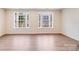 Spacious living room featuring hardwood floors and two large sunny windows at 416 Moondance Dr # 121, Gastonia, NC 28054