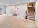 Spacious living room featuring neutral carpet, staircase, and plenty of natural light at 416 Moondance Dr # 121, Gastonia, NC 28054
