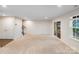 Expansive living room boasts neutral carpet, patio doors, and ample natural light at 416 Moondance Dr # 121, Gastonia, NC 28054