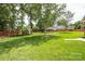 Spacious backyard featuring mature trees, a shed, and a well-maintained lawn at 4320 Atkinson Way, Monroe, NC 28110