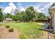 Spacious backyard with lush green lawn, mature trees, storage shed, and patio seating area at 4320 Atkinson Way, Monroe, NC 28110