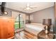 Bedroom with hardwood flooring, ceiling fan, natural light, and furniture including a dresser and daybed at 4320 Atkinson Way, Monroe, NC 28110