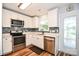 Bright kitchen featuring stainless steel appliances, white cabinetry, light countertops, and wood-look flooring at 4320 Atkinson Way, Monroe, NC 28110