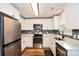 Well-lit kitchen featuring stainless steel appliances, gray backsplash, light countertops, and wood-look flooring at 4320 Atkinson Way, Monroe, NC 28110