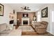 Comfortable living room with fireplace, tv, modern ceiling fan, and neutral color palette at 4320 Atkinson Way, Monroe, NC 28110
