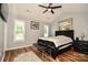 Vaulted ceiling bedroom with wood-look flooring, ceiling fan, bench at the foot of the bed and natural light at 4320 Atkinson Way, Monroe, NC 28110