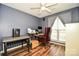 Office area with hardwood flooring, ceiling fan and bright natural light shining through the window at 4320 Atkinson Way, Monroe, NC 28110