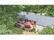 Aerial view of backyard featuring outdoor patio, mature trees and pristine landscaping at 441 Crestside Se Dr, Concord, NC 28025