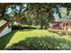 Large backyard featuring beautiful mature trees, green grass, and a cozy brick patio with seating at 441 Crestside Se Dr, Concord, NC 28025