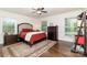 Inviting bedroom with hardwood floors, area rug, and large windows bringing in ample natural light at 441 Crestside Se Dr, Concord, NC 28025