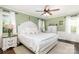 Serene bedroom boasts hardwood floors, soft green walls, and bright natural light from two windows at 441 Crestside Se Dr, Concord, NC 28025
