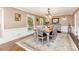 Comfortable dining room showcases hardwood floors, six chairs, an elegant chandelier, and natural lighting at 441 Crestside Se Dr, Concord, NC 28025
