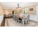 Elegant dining room with an extra-long wooden table, decorative chandelier, and a neutral color palette at 441 Crestside Se Dr, Concord, NC 28025
