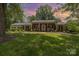 Charming brick home with a welcoming front porch, lush lawn, and mature trees at 441 Crestside Se Dr, Concord, NC 28025