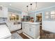 Bright kitchen with white cabinetry, stainless steel appliances, center island, and modern pendant lighting at 441 Crestside Se Dr, Concord, NC 28025
