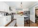 Modern kitchen with white cabinets, stainless appliances, hardwood floors, and island with seating at 441 Crestside Se Dr, Concord, NC 28025