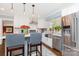 Stylish kitchen featuring stainless steel appliances, white cabinetry, backsplash, and island with barstool seating at 441 Crestside Se Dr, Concord, NC 28025