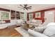 Inviting living room has built-in bookshelves, a large ceiling fan, hardwood floors, and natural light at 441 Crestside Se Dr, Concord, NC 28025