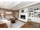 Cozy living room with fireplace, built-in shelving, hardwood floors, neutral walls and comfortable seating at 441 Crestside Se Dr, Concord, NC 28025