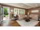 Cozy living room features hardwood floors, neutral paint, and sun-filled windows with plantation shutters at 441 Crestside Se Dr, Concord, NC 28025