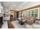 Comfortable living room with a fireplace, exposed beams, hardwood floors, and an inviting seating arrangement at 441 Crestside Se Dr, Concord, NC 28025