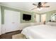Bright main bedroom featuring fresh green paint, white wainscoting, and an overhead fan with light at 441 Crestside Se Dr, Concord, NC 28025