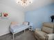 Bedroom with light blue walls, modern ceiling fan, comfortable recliner chair, and a bed at 4607 Silk Tree Ln, Rock Hill, SC 29732