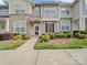 Attractive townhome with stone accents, a black front door, shuttered windows, and landscaped front yard at 4607 Silk Tree Ln, Rock Hill, SC 29732