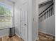Bright hallway with wood-look flooring, featuring a staircase and natural light from a nearby window at 4607 Silk Tree Ln, Rock Hill, SC 29732