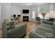 Inviting living room features a cozy fireplace, hardwood floors, and bright natural light at 4607 Silk Tree Ln, Rock Hill, SC 29732