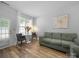 Relaxing living room with a comfortable sofa, hardwood floors, and a table next to a window at 4607 Silk Tree Ln, Rock Hill, SC 29732