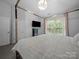 Sun-filled main bedroom with window, a four-poster bed, TV, and two entry doors at 4607 Silk Tree Ln, Rock Hill, SC 29732