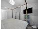 Main bedroom with decorative light fixture, black TV, and two entry doors at 4607 Silk Tree Ln, Rock Hill, SC 29732