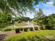 Tranquil pond with a fountain feature, lush greenery, and mature trees, offering a serene view at 4607 Silk Tree Ln, Rock Hill, SC 29732